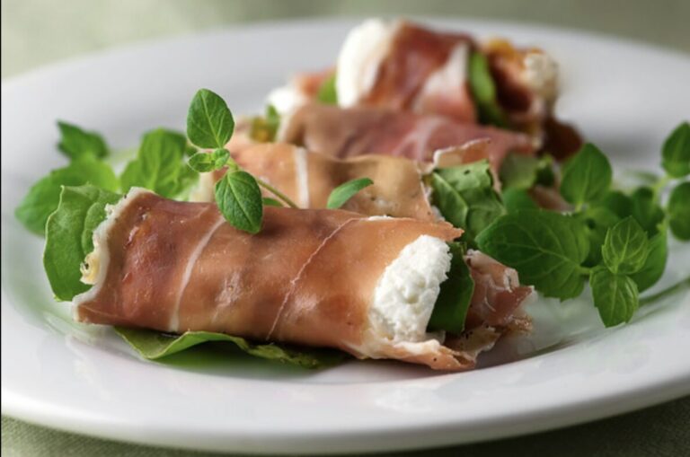 Prosciutto cheese rolls on a plate.